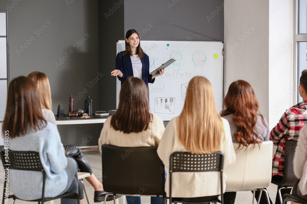 Professional hairdresser teaching young people in office