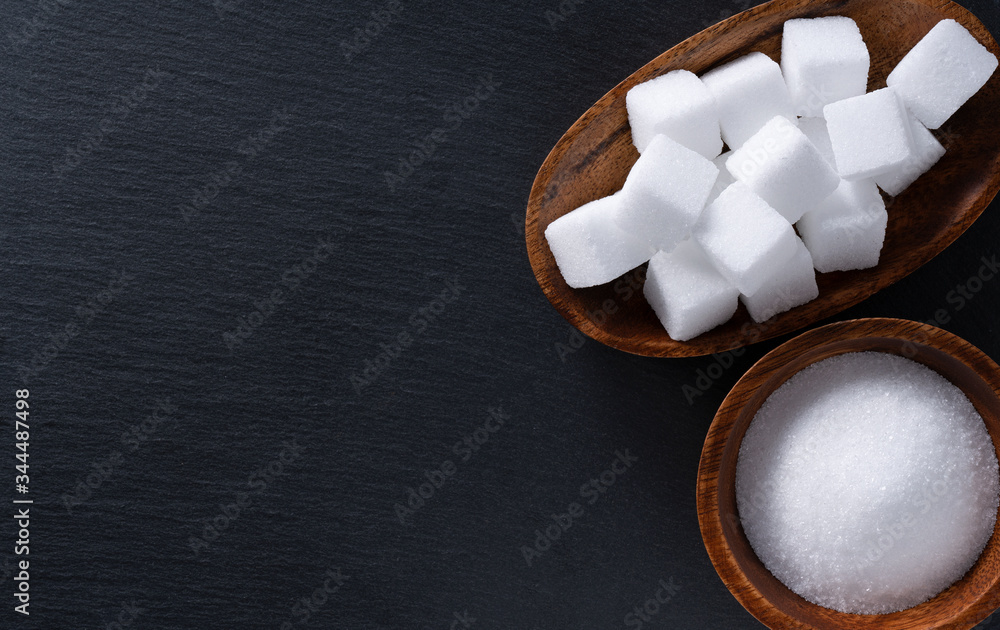 Sugar and lump sugar placed on a black background with space