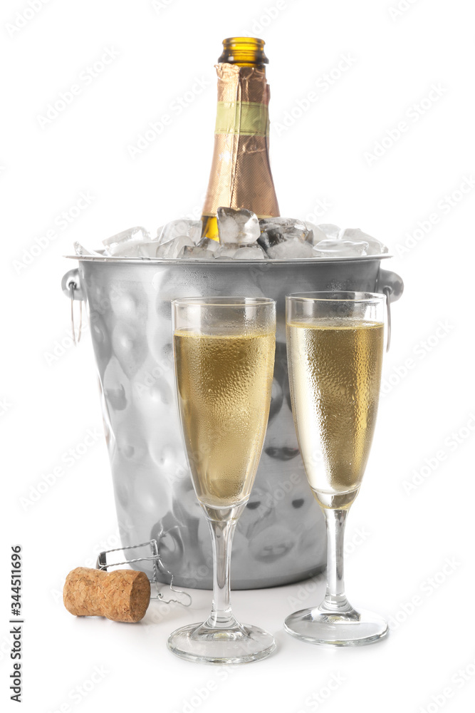 Bucket with bottle and glasses of champagne on white background