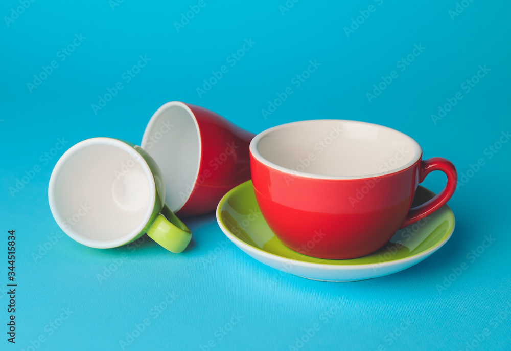 Blank cups on color background