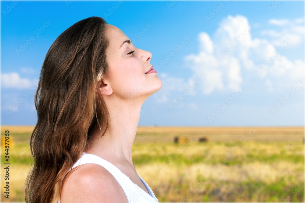 Happy young woman with perfect skin on outdoor background