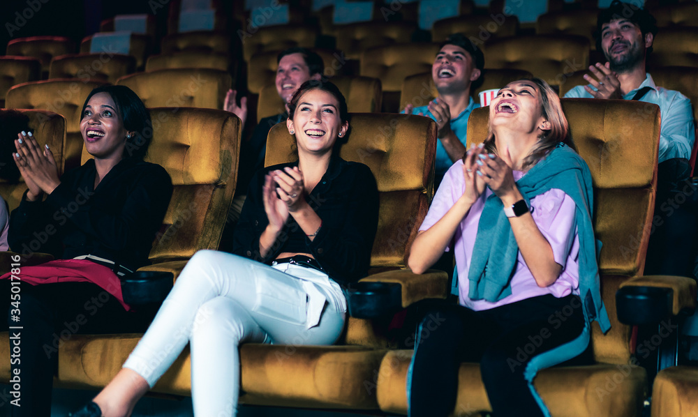 People audience watching movie in the movie theater cinema. Group recreation activity and entertainm