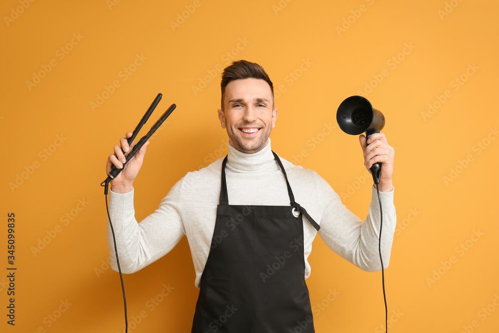 Male hairdresser on color background