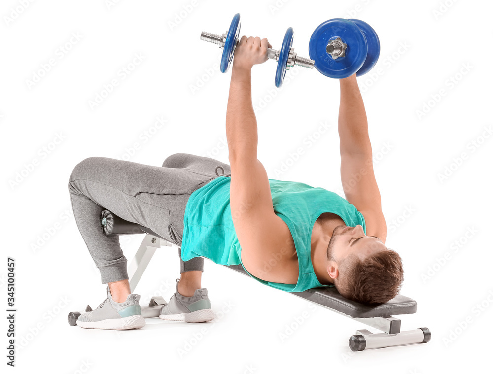 Sporty young man training with dumbbells on white background