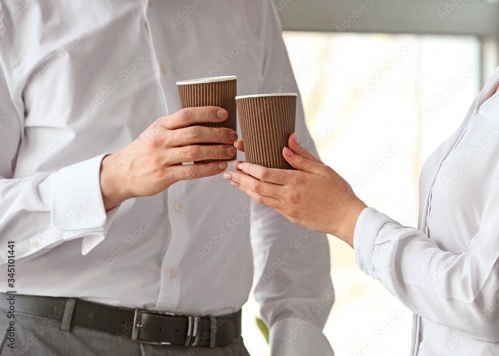 Young colleagues drinking coffee in office