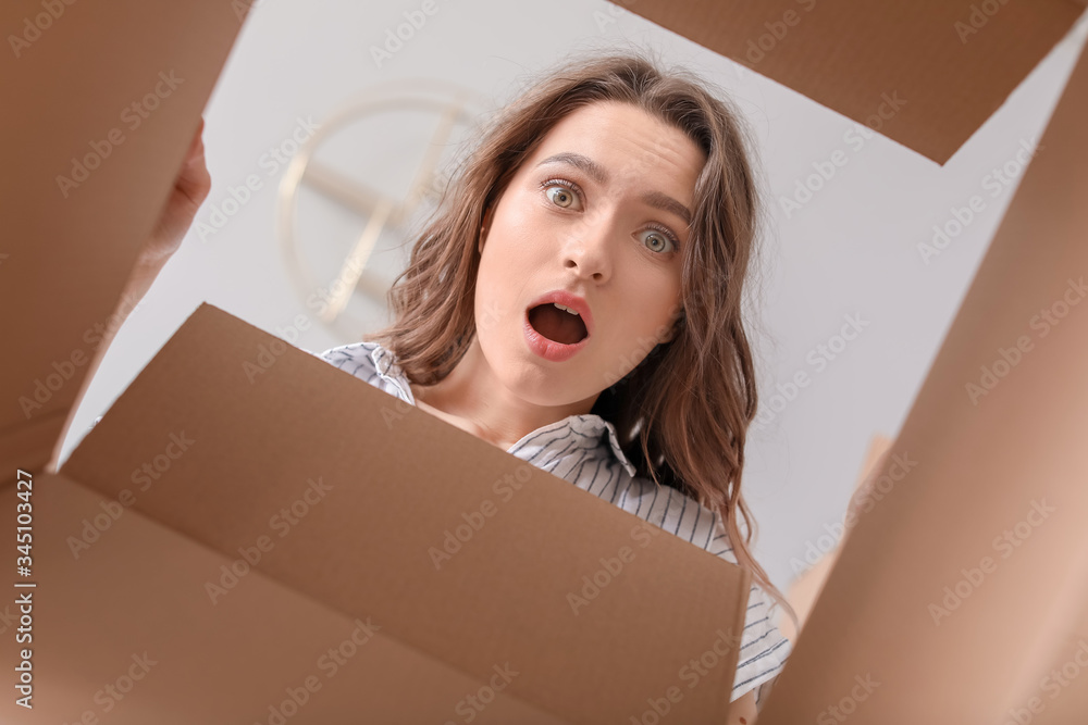 Troubled woman with open box, view from inside