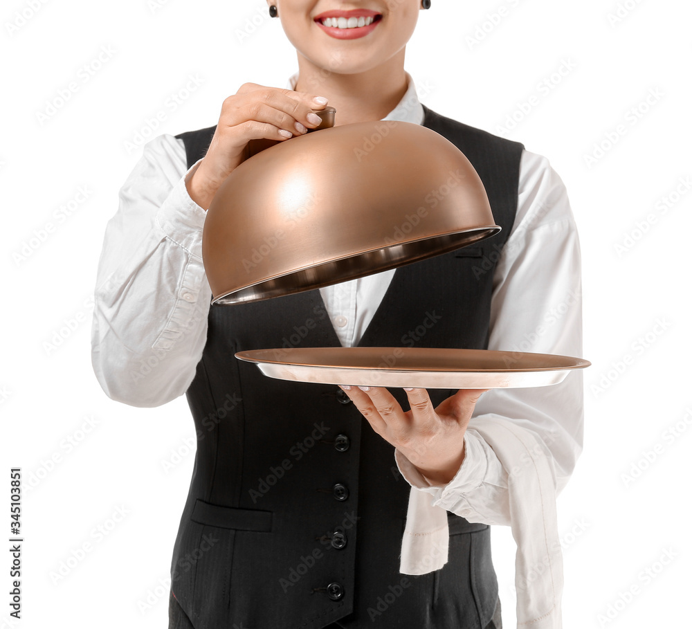 Beautiful female waiter with tray and cloche on white background