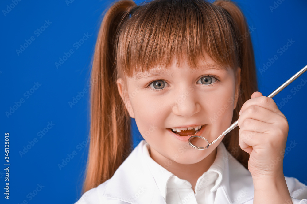 Little dentist with mirror on color background