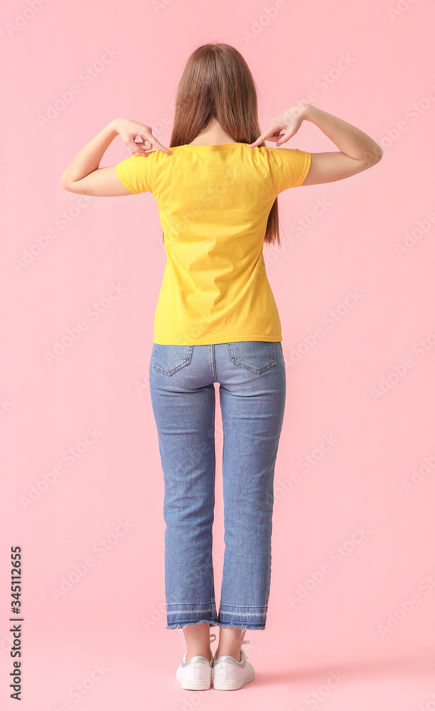 Young woman in stylish t-shirt on color background