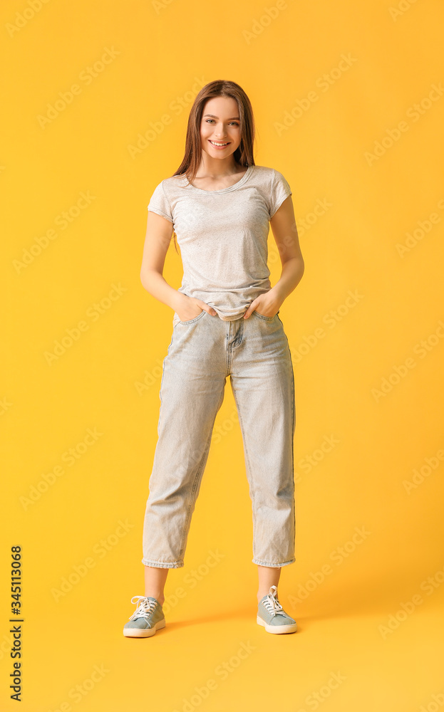 Young woman in stylish t-shirt on color background