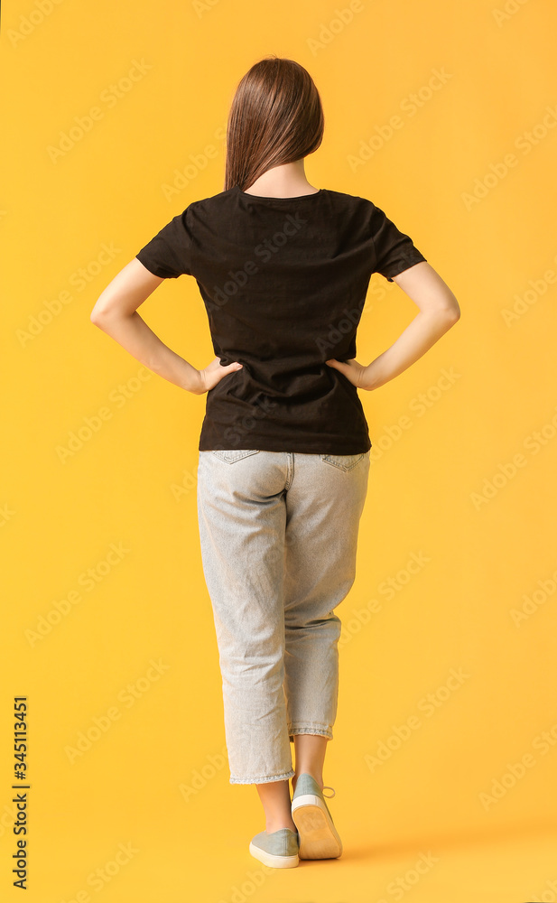 Young woman in stylish t-shirt on color background