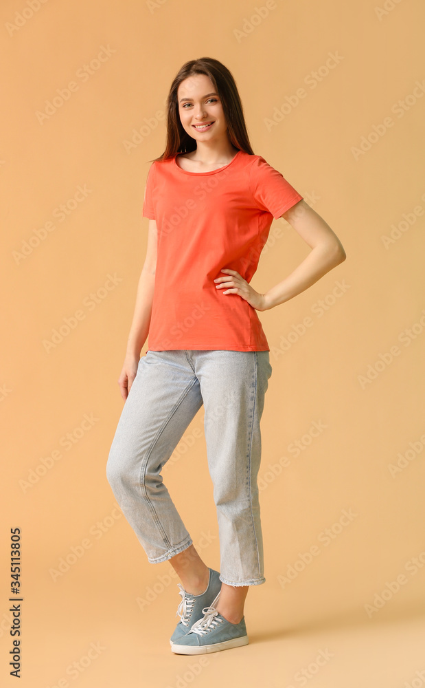 Young woman in stylish t-shirt on color background