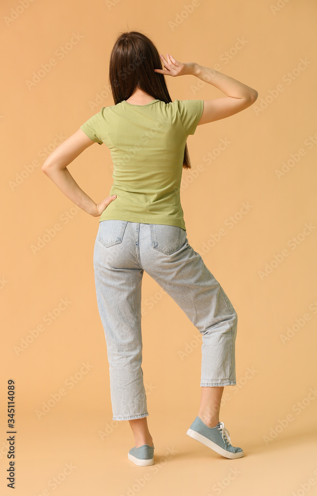 Young woman in stylish t-shirt on color background