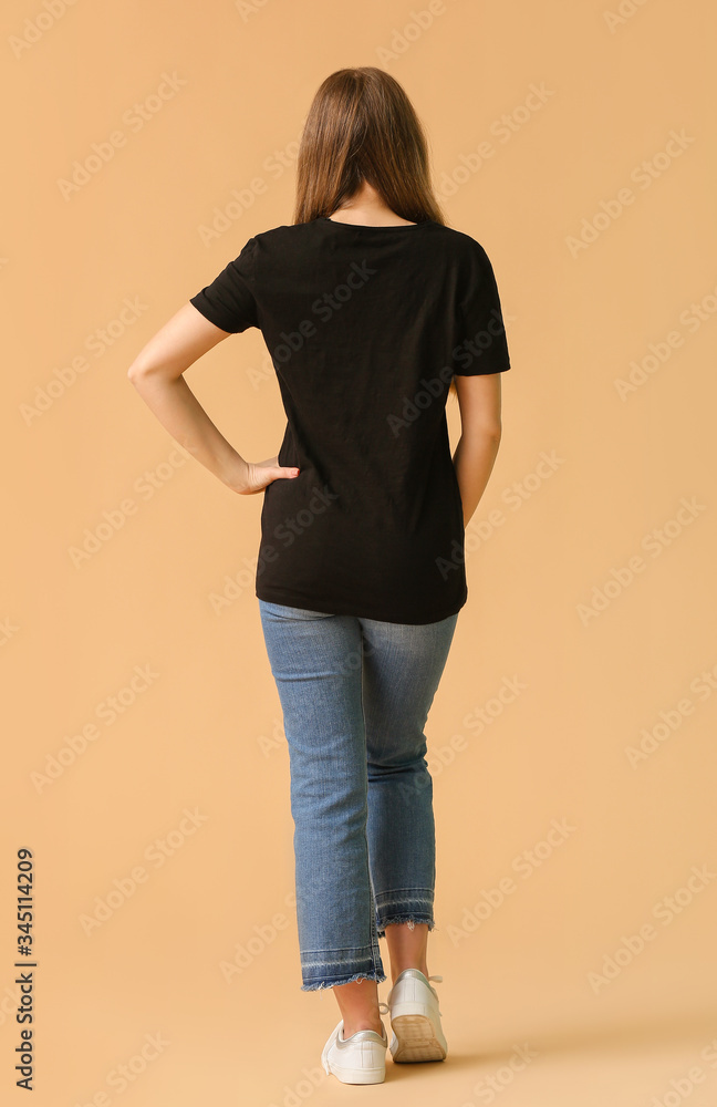 Young woman in stylish t-shirt on color background