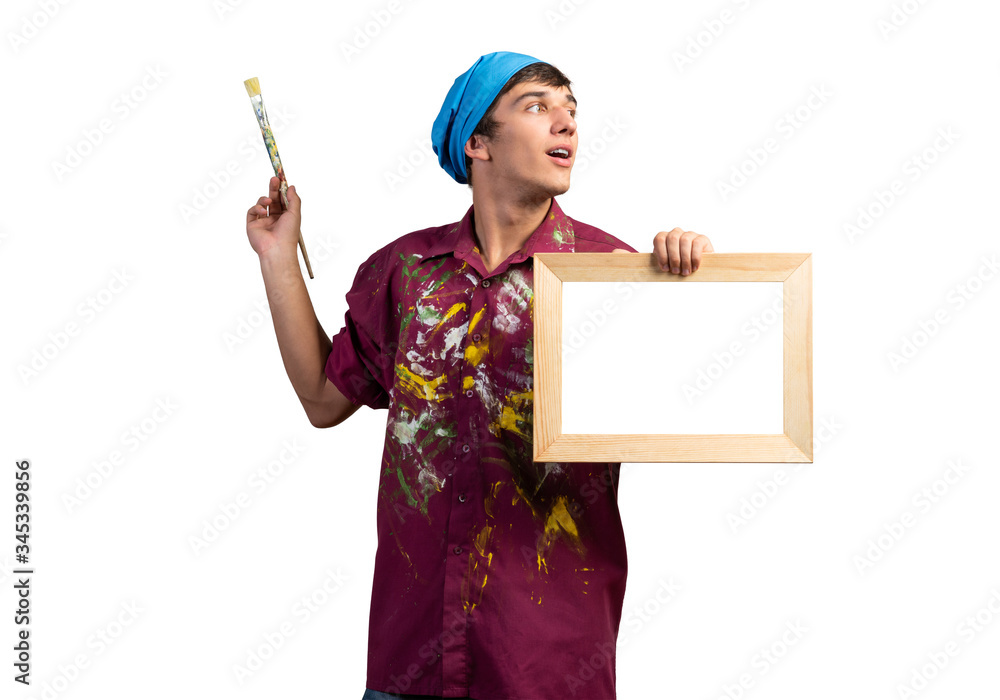 Young handsome painter artist holding paintbrush