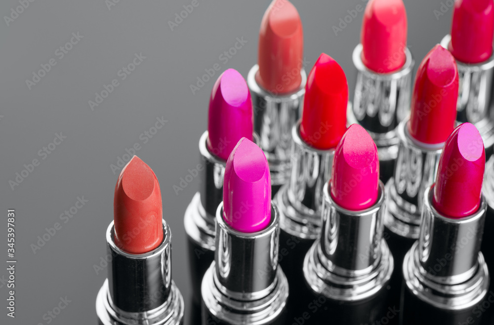 Lipstick. Fashion Colorful Lipsticks over black background. Lipstick tints palette, Professional Mak