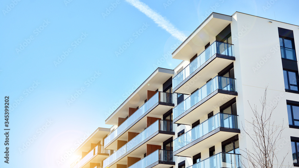 Modern apartment buildings on a sunny day with a blue sky. Facade of a modern apartment building. Gl