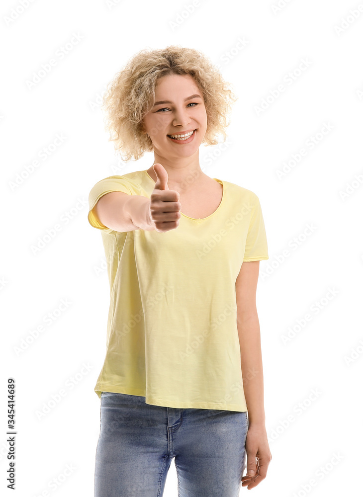 Beautiful young woman showing thumb-up gesture on white background