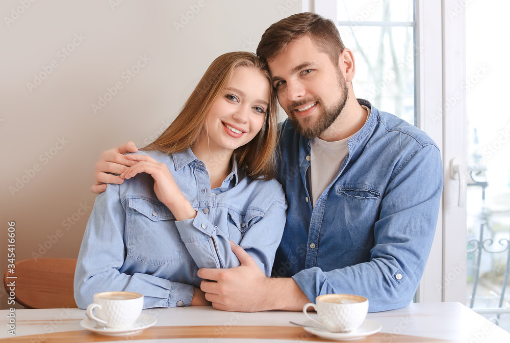 Young couple drinking coffee in cafe