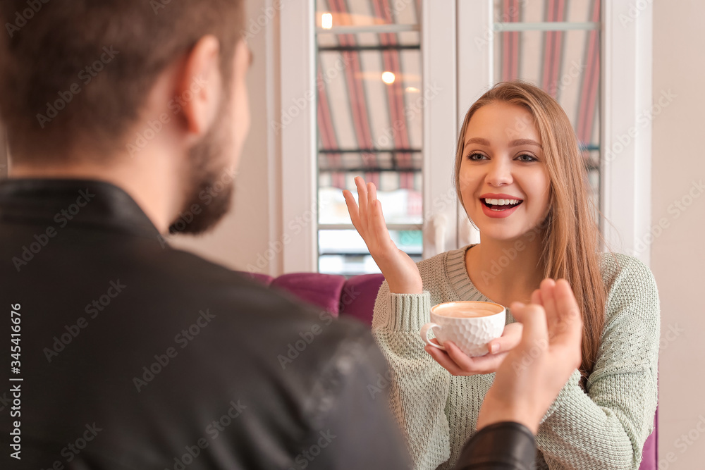 Young couple drinking coffee in cafe