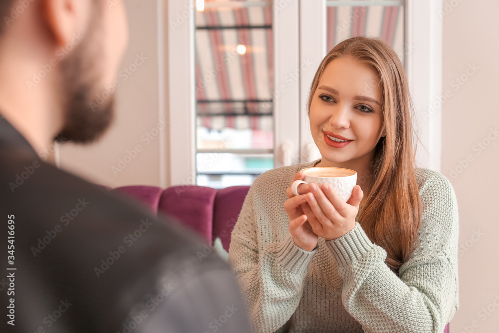 Young couple drinking coffee in cafe