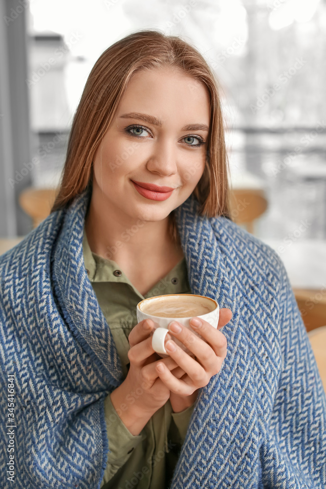 Young woman drinking coffee in cafe