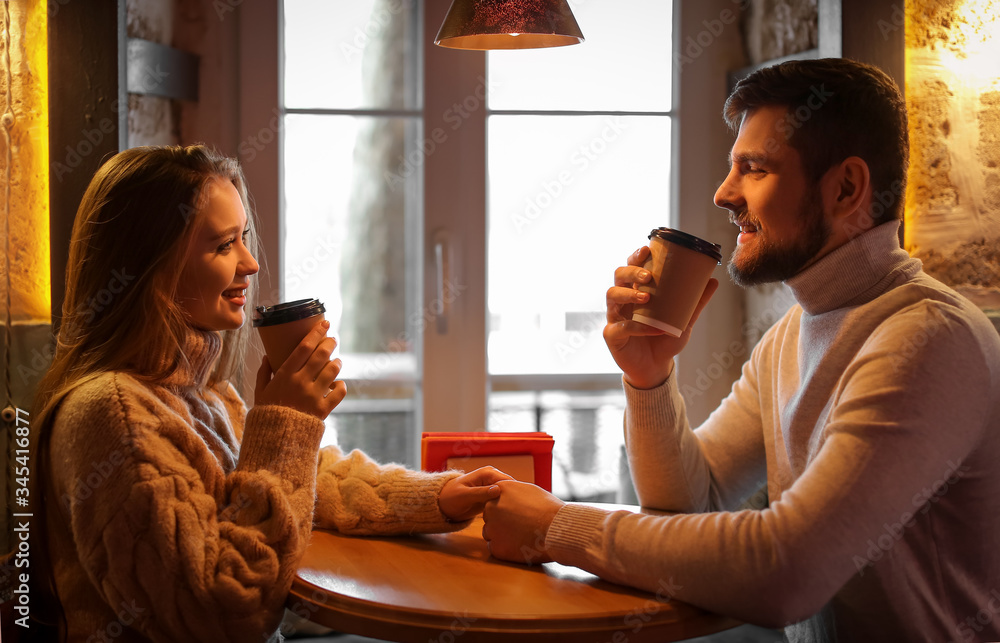 Young couple drinking coffee in cafe