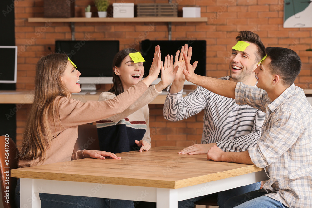 Team of business people holding hands together in office