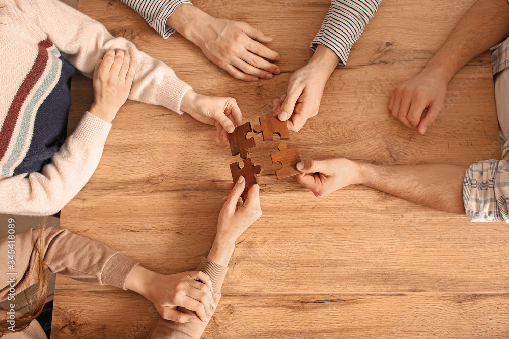 Team of business people doing puzzle in office