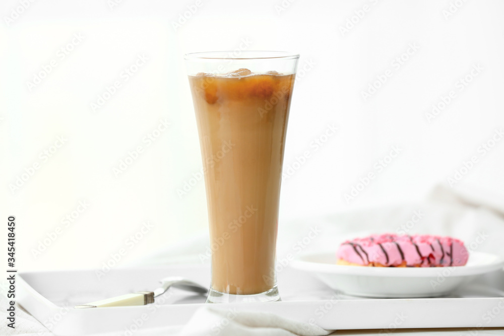 Glass of tasty iced coffee on table