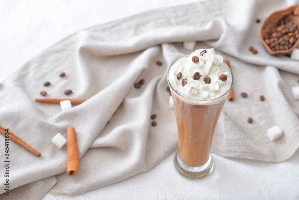 Glass of tasty iced coffee on table