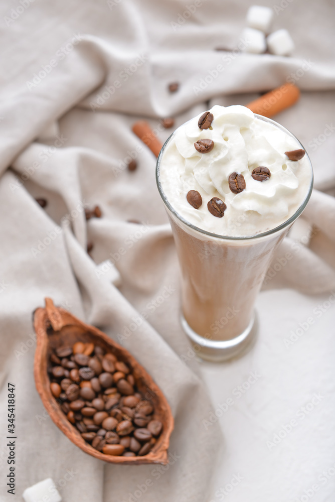 Glass of tasty iced coffee on table