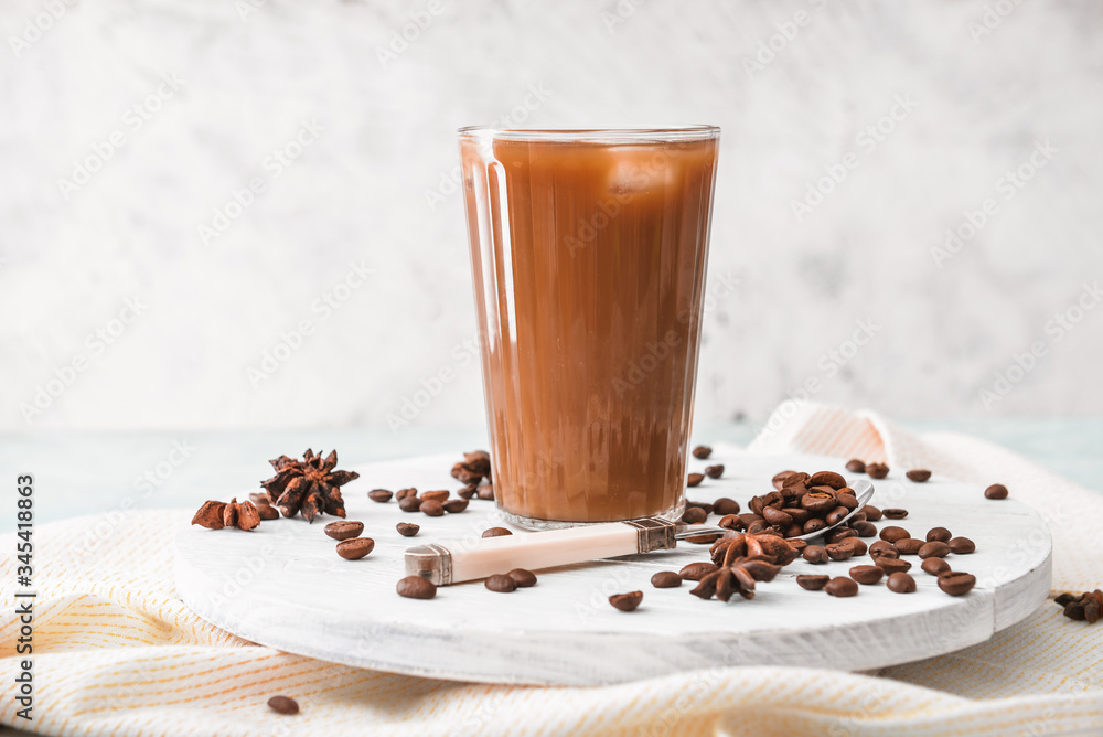 Glass of tasty iced coffee on table