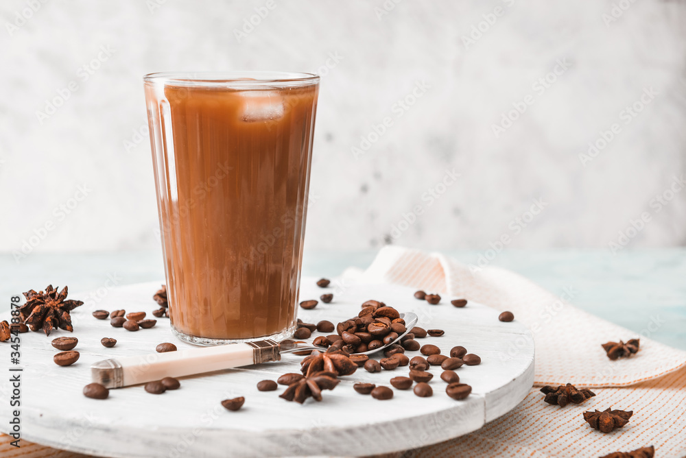 Glass of tasty iced coffee on table