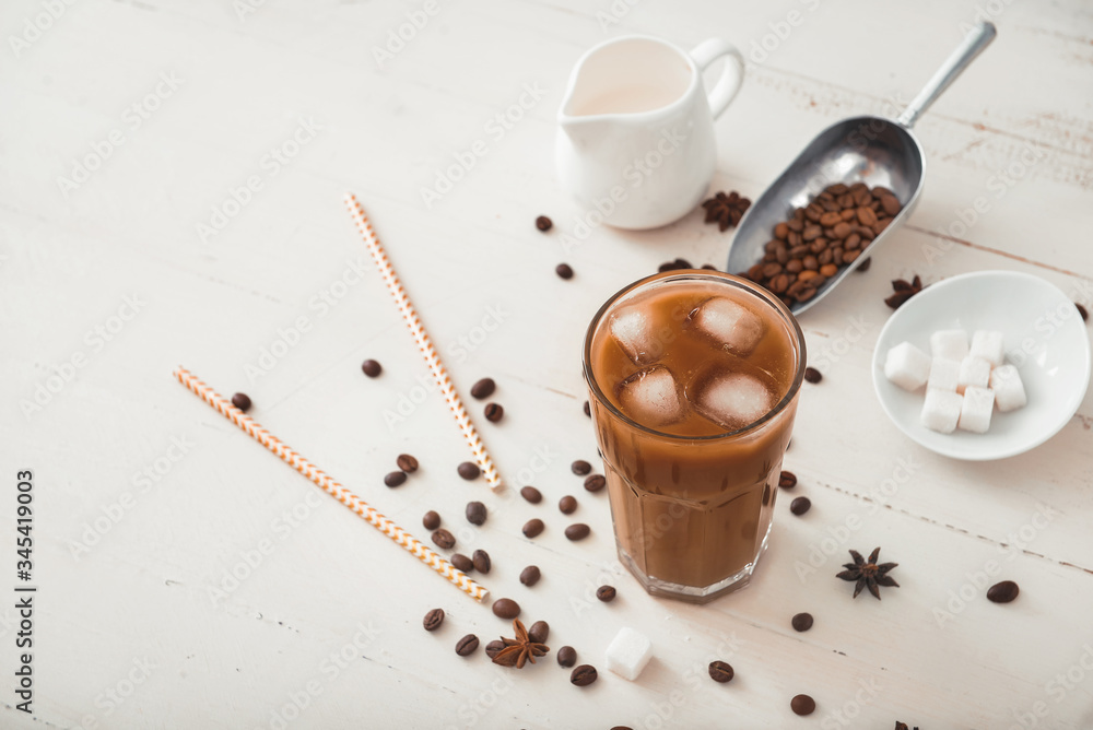 Glass of tasty iced coffee on table