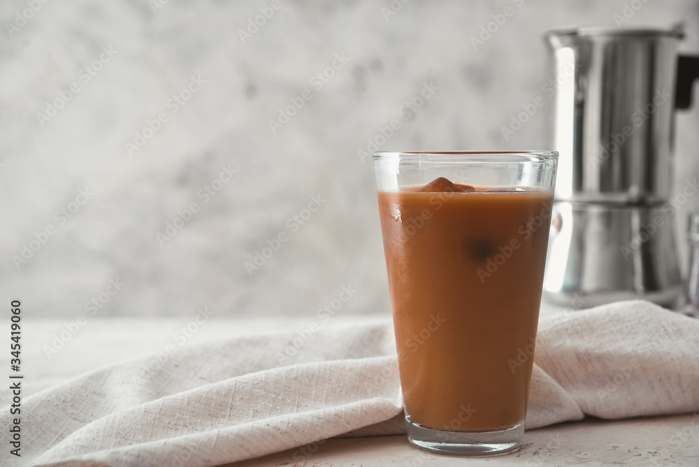 Glass of tasty iced coffee on table