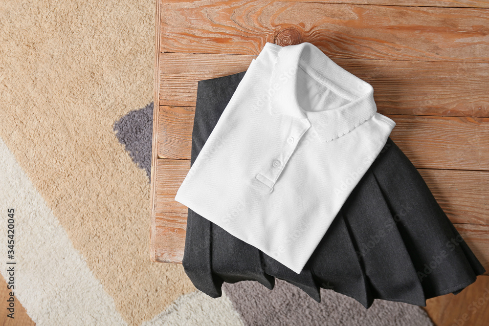 Stylish school uniform on wooden table