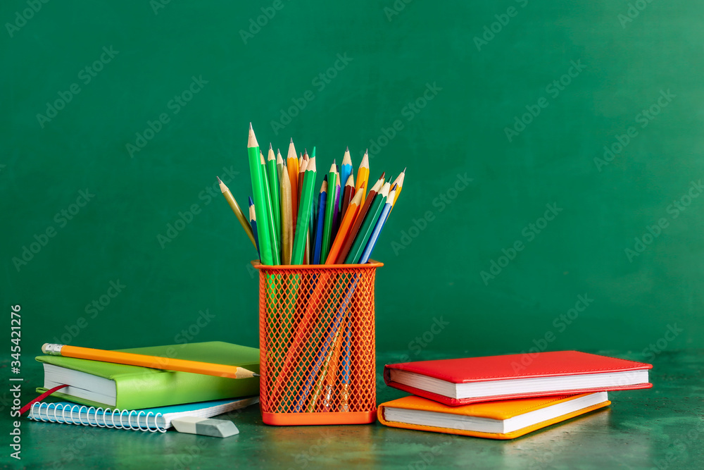 Holder with stationery on color background