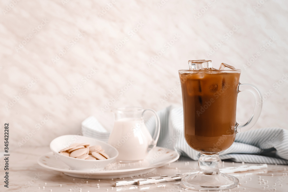 Cup of tasty cold coffee on light background