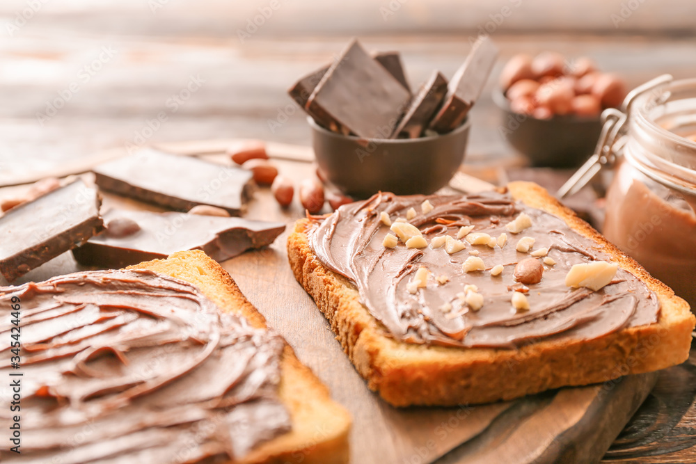 Fresh bread and chocolate paste on board, closeup