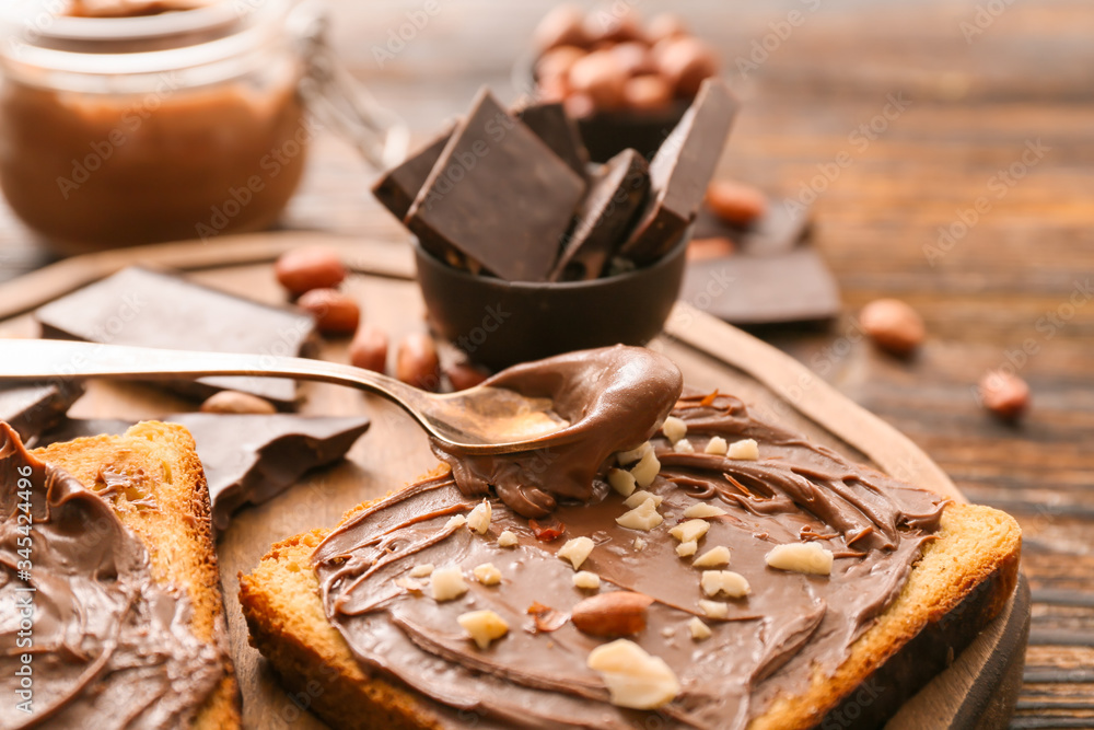 Fresh bread and chocolate paste on board, closeup