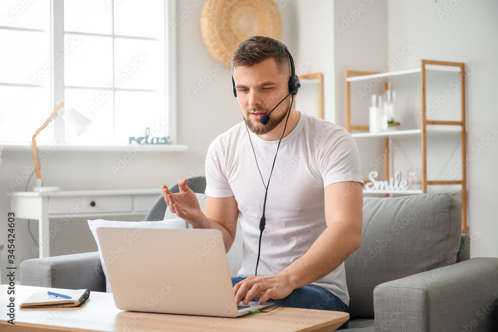 Male technical support agent working at home