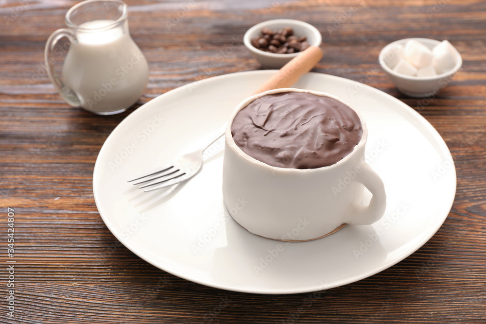 Chocolate cake in shape of coffee cup on table