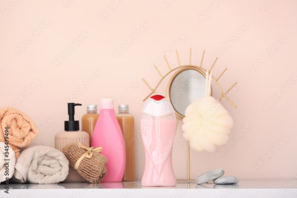 Shower gels, towels and loofah in bathroom