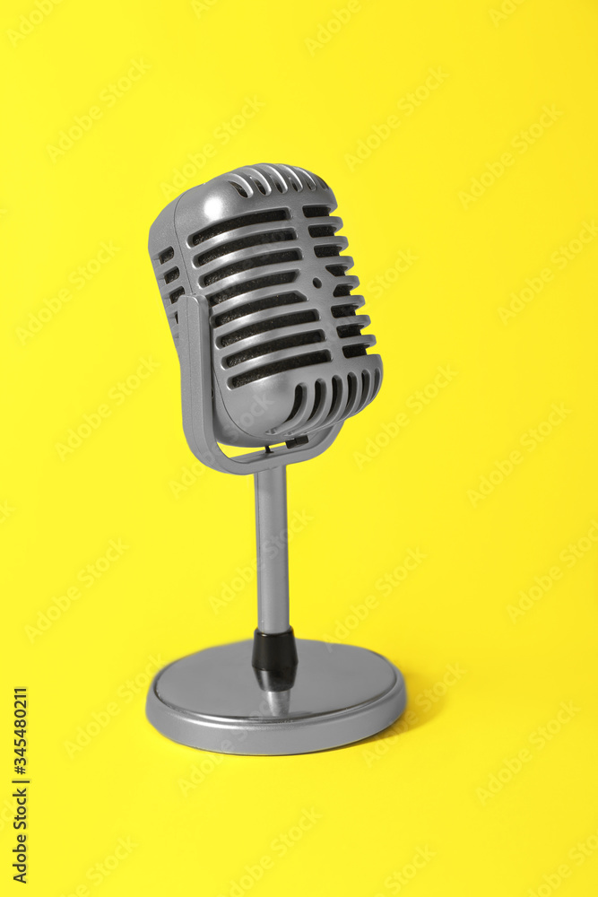 Retro microphone on color background