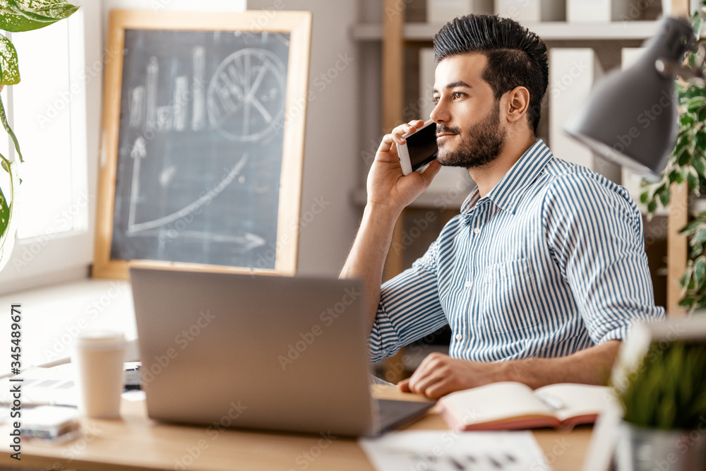 man working on a laptop at home.