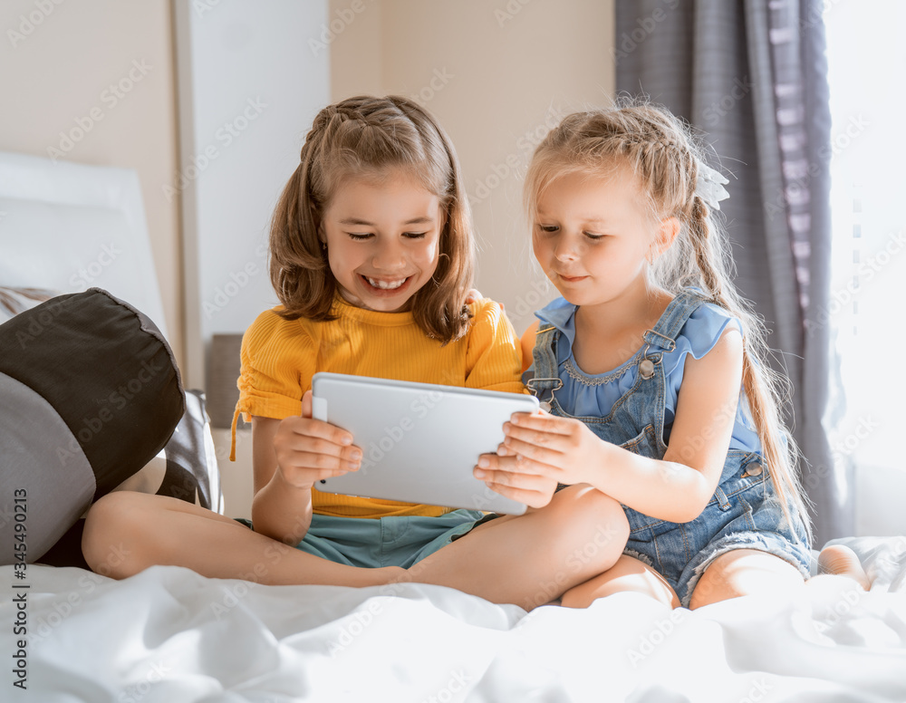 children are playing with tablet