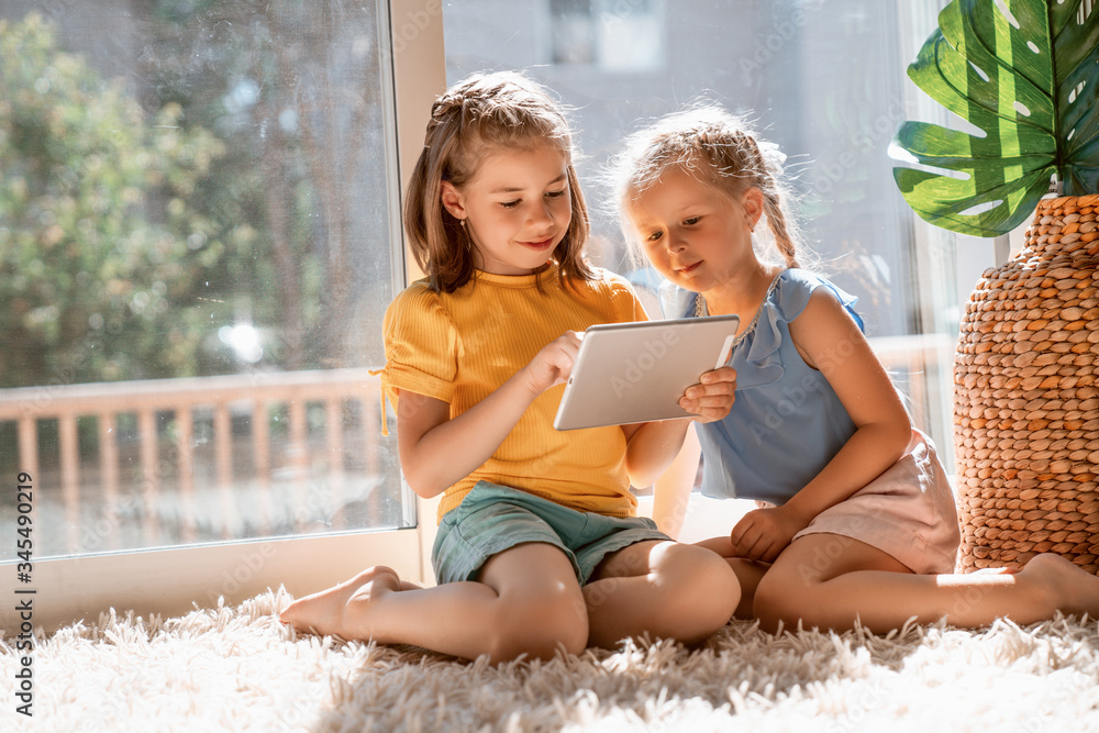 children are playing with tablet