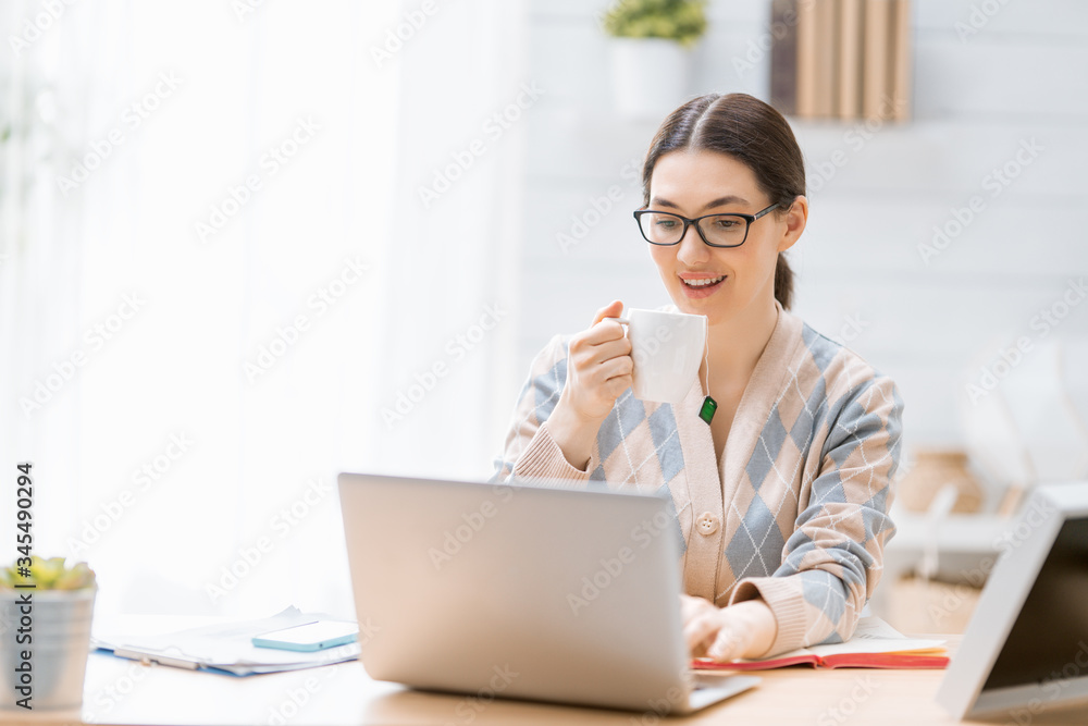 woman working on a laptop at home.