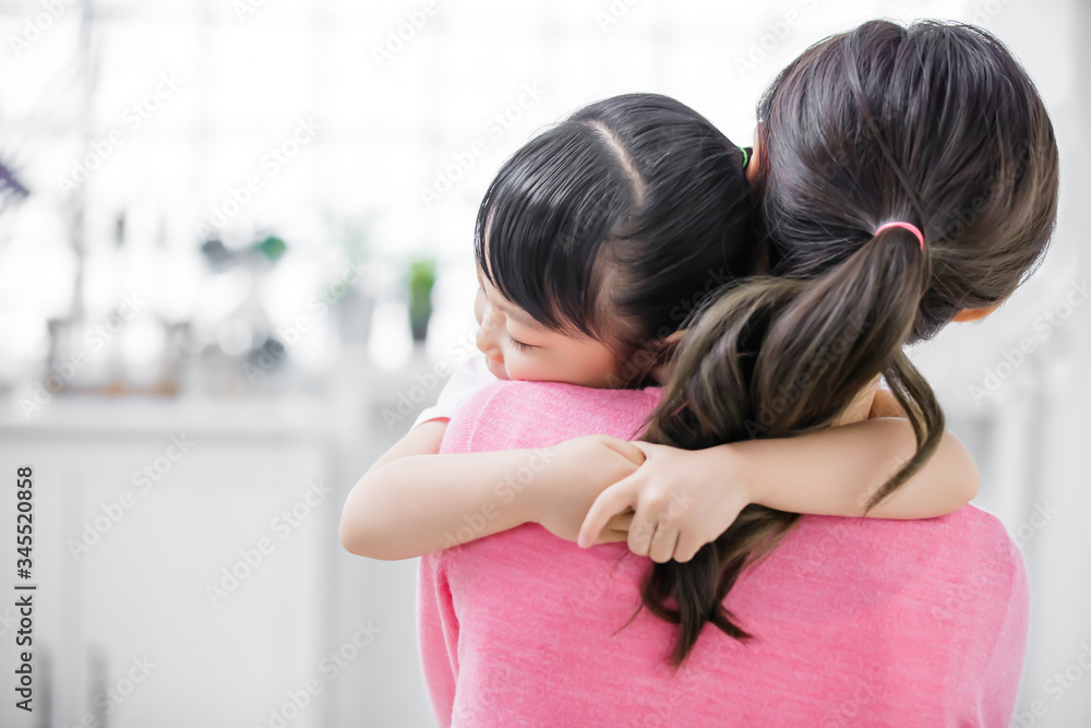 Mom hug daughter in her arm